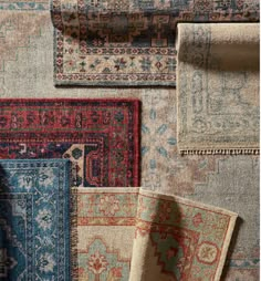 rugs with different colors and patterns are arranged on the floor in an arrangement,