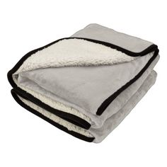 two blankets folded on top of each other with black and white trims in the middle