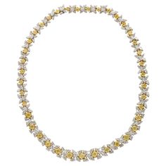 An exquisitely designed piece! 43.87 of Fancy Yellow and white diamonds set in 18k yellow and white gold. Fancy Yellow cushion cut diamonds are set between white pear and marquise cut diamonds. Featuring 2 locks with an extension - the necklace can be worn at 16.5 or 15 inch lengths. Half an inch wide in the center A beautiful wreath necklace! Matching earrings are available in our 1stDibs store. Luxury Hallmarked Yellow Gold Bridal Necklace, Luxury Yellow Gold Necklaces With Diamond Accents, Luxury Traditional Yellow Gold Diamond Necklace, Yellow Diamond Necklace, Wreath Necklace, White Diamond Necklace, Yellow Cushion, Yellow Cushions, Diamond Choker