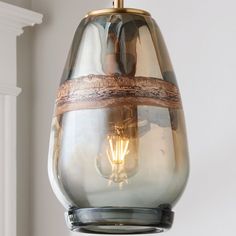 a glass light hanging from the ceiling in a room with white walls and mold mold mold mold