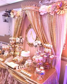 a table topped with lots of cakes and cupcakes