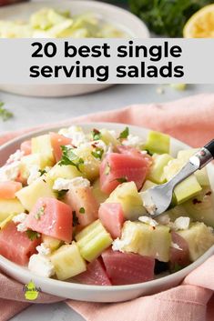 a white bowl filled with watermelon, cucumber and feta cheese salad