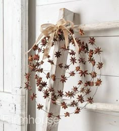 an old ladder is decorated with dried flowers