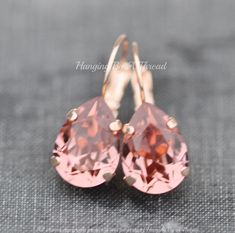 "Gorgeous new earrings made using Swarovski crystals. The earrings feature pear shaped crystals, in blush rose color. It's a lovely shade of pale burgundy. This color was discontinued two years ago, and is being brought back in limited quantities. Crystal is 14mm long (over 1/2\") and set into a premium prong setting with lever back ear wire. Total drop length is a hair under 1\". Shown in rose gold, but also available in silver, gold, and antique brass. Please choose desired metal finish at checkout.  ** MADE TO MATCH: https://www.etsy.com/listing/1161983215/new-color-swarovski-blush-rose-large?click_key=49998dcf53a6fae0b1f555814217d68dae08563d%3A1161983215&click_sum=62939751&ga_search_query=blush%2Brose&ref=shop_items_search_11&pro=1&frs=1&sts=1 ** Nickel and lead free" Light Burgundy, Shaped Crystals, Earrings Rose Gold, Blush Rose, Crystal Drop Earrings, Blush Roses, Crystal Drop, Rose Earrings, Pink Light