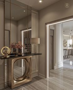 the interior of a modern home with marble flooring and gold accents on the walls