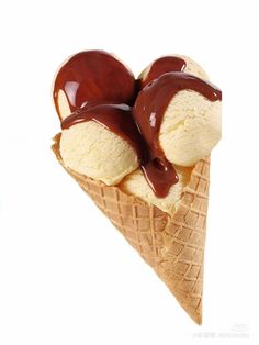 two scoops of ice cream with chocolate sauce on top, sitting in an ice cream cone