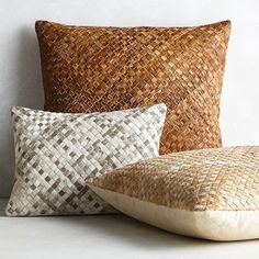 two pillows and a pillow on a white surface