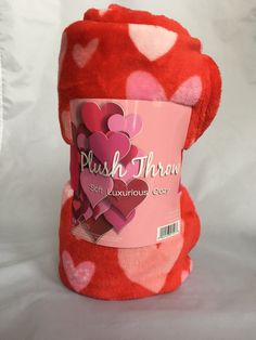 a pink and red teddy bear with hearts on it