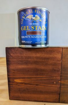 a can of gel stain sitting on top of a wooden block