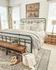 a bed room with a neatly made bed and a wooden bench next to the bed