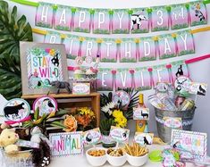 a table filled with lots of food and decorations for a birthday or baby's first birthday