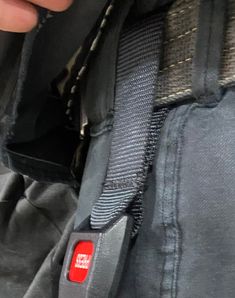 the back end of a person's jacket with a red tag on it,