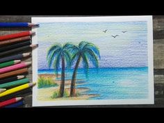 colored pencils next to a drawing of two palm trees