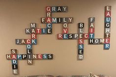 a living room filled with furniture and scrabble tiles on the wall above it