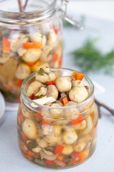 two jars filled with food sitting on top of a table