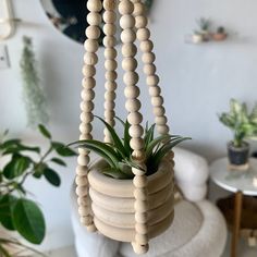 a wooden bead plant hanger in a living room