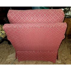 two pink upholstered chairs sitting next to each other