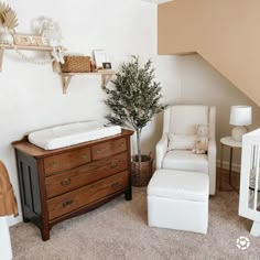 a baby's room with a crib, rocking chair and dresser in it