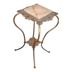 a small table with a marble top and metal frame on it's legs, against a white background