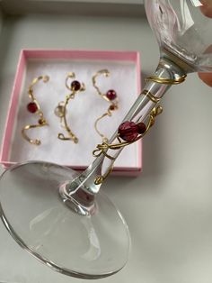 a person is holding a wine glass in front of some other items on a table