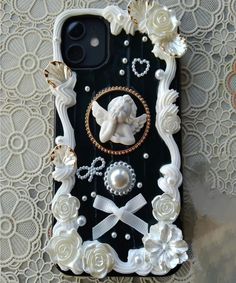 an iphone case with pearls and flowers on it