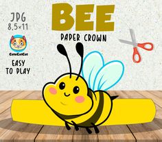 a cartoon bee sitting on top of a wooden table next to a pair of scissors