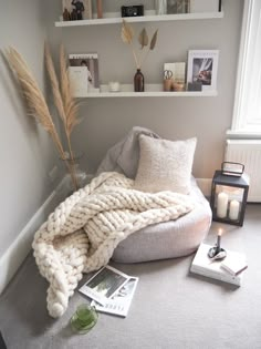 a living room with a bean bag chair and books on the floor next to it