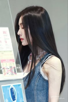 a woman standing in front of a vending machine with her hand on top of the vending machine