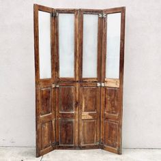 an old wooden double door with glass panels