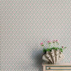 a vase filled with flowers sitting on top of a dresser