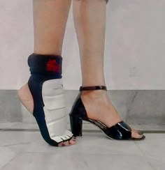 a woman's legs wearing black and white shoes