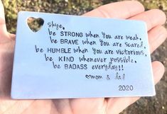 a hand holding a piece of paper with writing on it that says, she's strong when you are weak, be brave when you are scared, be humble when you are victorious