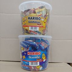 two plastic containers filled with various types of candy