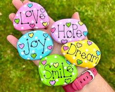 four rocks that say love hope joy dream smile