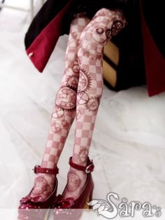 a woman wearing red high heels and patterned stockings