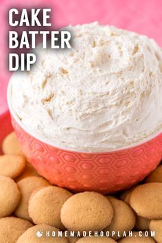 a red bowl filled with cake batter dip surrounded by cookies on a pink plate and text overlay