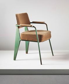 a chair that is sitting in the middle of a room with a white wall behind it