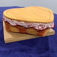 a wooden basket sitting on top of a blue rug