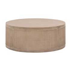 a round coffee table with beige linen on the top and bottom, in front of a white background