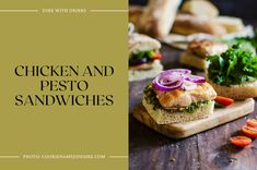 chicken and pesto sandwiches on a cutting board with red onion, lettuce, tomato slices