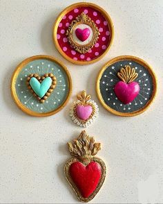 four decorative items are displayed on a white counter top with polka dots and gold trim