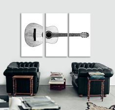 a living room with two couches and a guitar on the wall