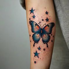 a woman's arm with a butterfly and stars tattoo on the left side of her leg