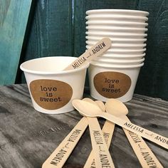 personalized wooden spoons and cups on a table with labels for love is sweet