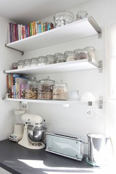 a kitchen with shelves filled with food and appliances