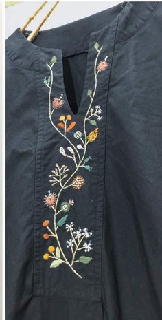 an embroidered shirt with flowers and leaves on it, next to a photo of the back of