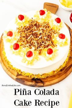 a cake with pineapples and cherries on top sits on a cutting board