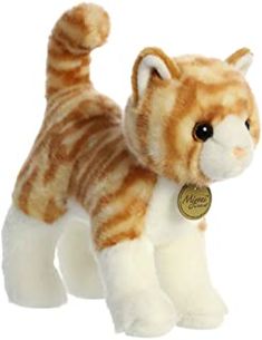 a brown and white cat stuffed animal with a tag on it's collar, standing upright