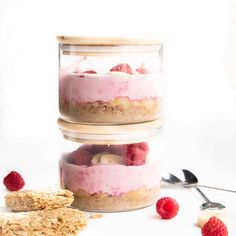 three layered desserts stacked on top of each other with raspberries and oatmeal