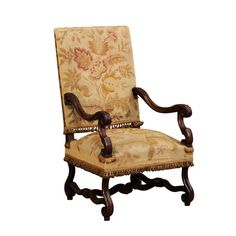 an old fashioned chair with floral upholstered back and arm rests against a white background